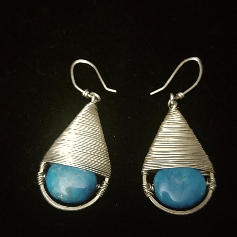 Turquoise stone and silver hand crafted teardrop earrings.